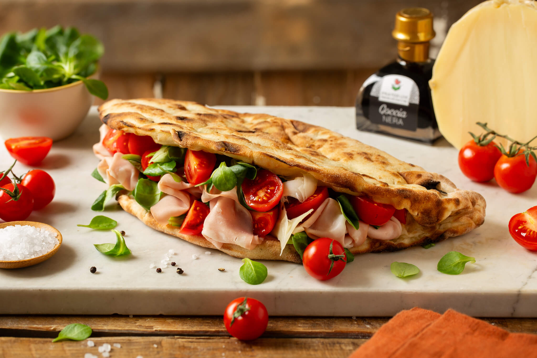 SMILE PIZZA with mortadella, mild provolone, lamb's lettuce and balsamic vinegar